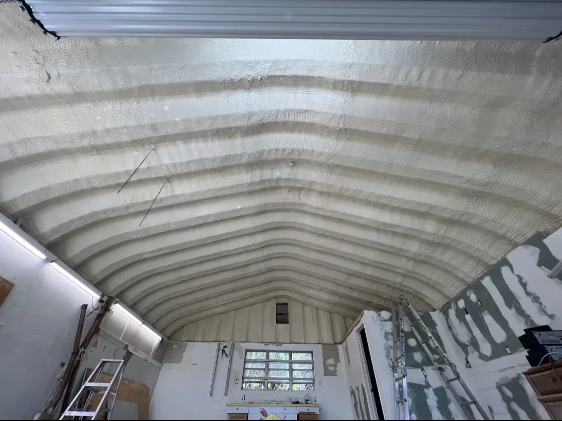 Spray polyurethane foam applied to the underside of a metal roof deck in Willard